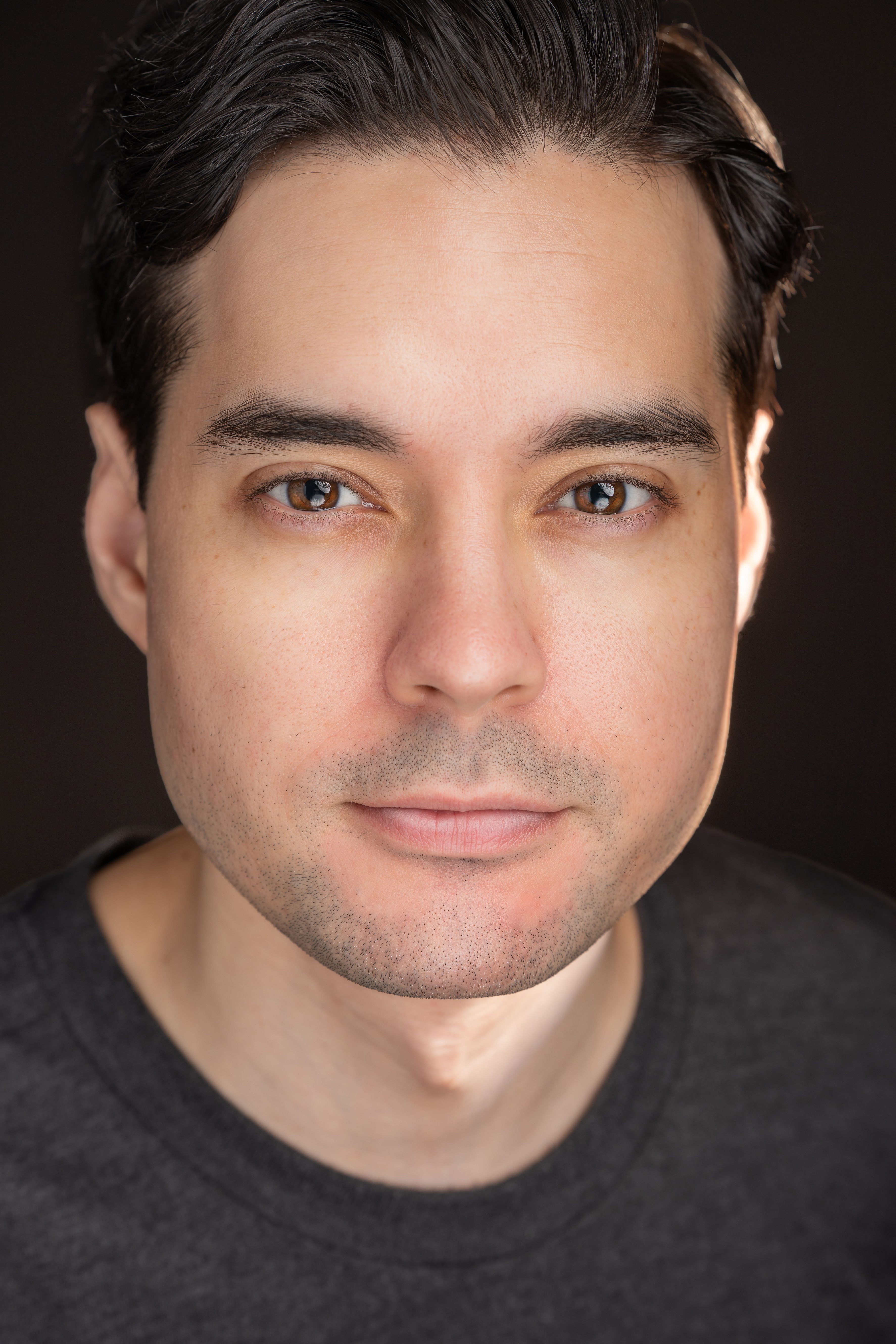 Reframe and crop the existing photo in a more flattering way while keeping the same person centered and clearly visible. Maintain a clean, professional, high-quality portrait look suitable for a coaching website.